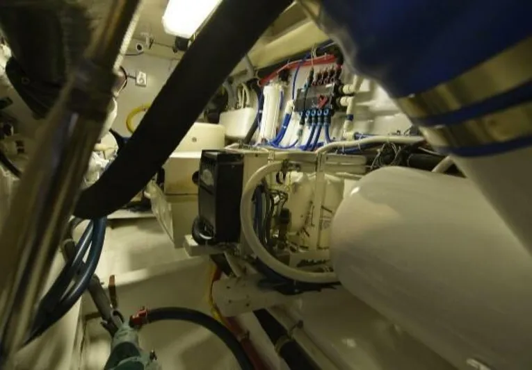 Burnin Daylight Yacht Photos Pics Engine room of 2006 Hatteras 50 Convertible yacht, showcasing complex machinery and wiring.