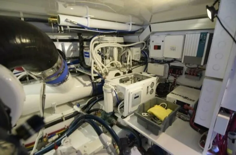 Burnin Daylight Yacht Photos Pics Engine room of 2006 Hatteras 50 Convertible yacht, showcasing complex machinery and equipment.