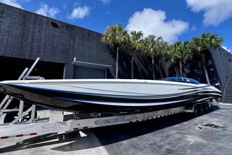  Yacht Photos Pics 2025 MTI 440 powerboat on trailer, sleek design, parked near modern building.