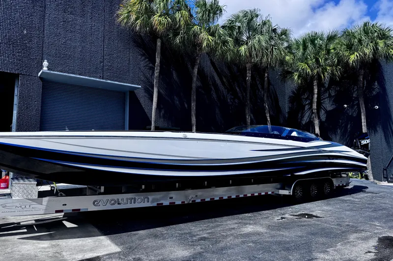  Yacht Photos Pics 2025 MTI 440 powerboat on trailer, sleek design, parked near palm trees.