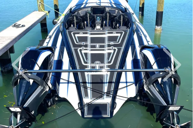  Yacht Photos Pics 2025 MTI 440 powerboat docked, showcasing sleek design and dual engines.