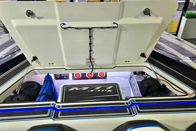  Yacht Photos Pics Open engine compartment of 2025 MTI 440 boat with visible components and storage.