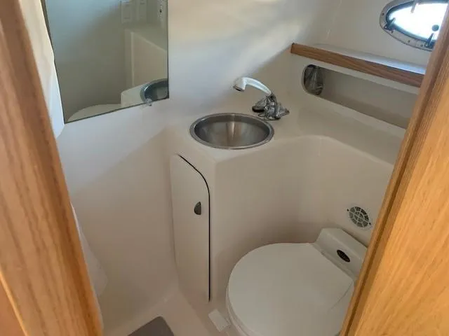 Mickadoo Yacht Photos Pics 2001 Tiara Yachts 3100 bathroom with sink, toilet, and mirror.