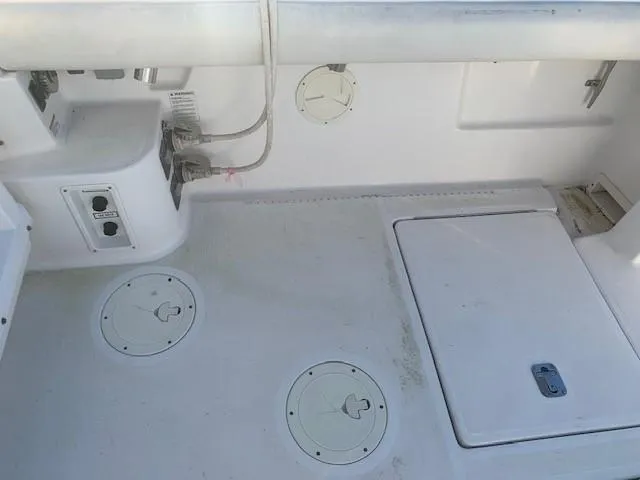 Mickadoo Yacht Photos Pics 2001 Tiara Yachts 3100 deck with storage compartments and utility access.