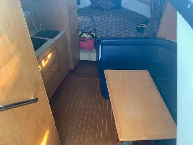 Mickadoo Yacht Photos Pics 2001 Tiara Yachts 3100 interior with kitchenette, seating area, and bed.