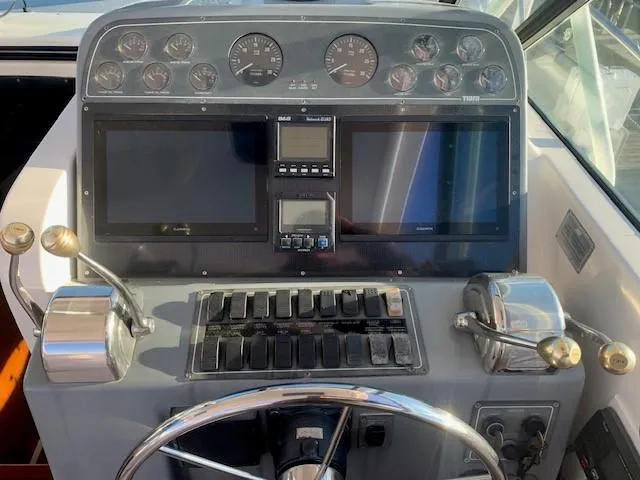 Mickadoo Yacht Photos Pics Helm of 2001 Tiara Yachts 3100 with dual screens and control panel.