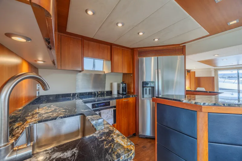 My Sirena Yacht Photos Pics Luxurious kitchen interior of 2008 Sunseeker Manhattan 70 yacht with modern appliances and marble countertops.