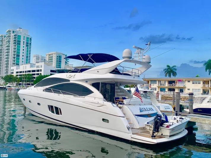 My Sirena Yacht Photos Pics 2008 Sunseeker Manhattan 70 yacht docked in a marina, surrounded by modern buildings.