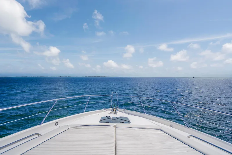 My Sirena Yacht Photos Pics Sunseeker Manhattan 70 yacht cruising on open sea under clear blue sky.