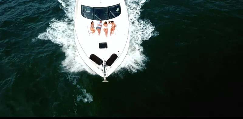 My Sirena Yacht Photos Pics Aerial view of 2008 Sunseeker Manhattan 70 yacht cruising with passengers on deck.