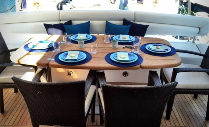 My Sirena Yacht Photos Pics Elegant dining setup on 2008 Sunseeker Manhattan 70 yacht, featuring stylish tableware and seating.