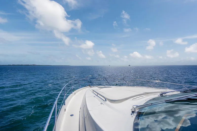 My Sirena Yacht Photos Pics Sunseeker Manhattan 70 yacht cruising on open sea under clear blue sky, 2008 model.