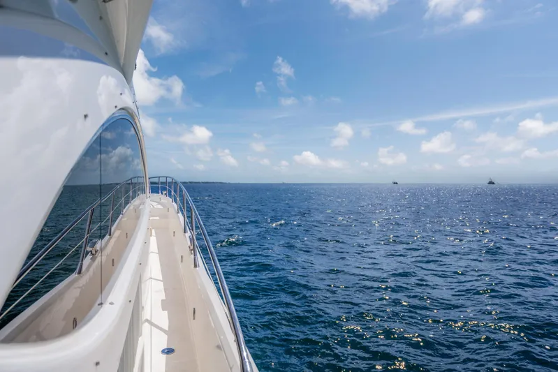My Sirena Yacht Photos Pics Side view of 2008 Sunseeker Manhattan 70 yacht cruising on a clear blue ocean.