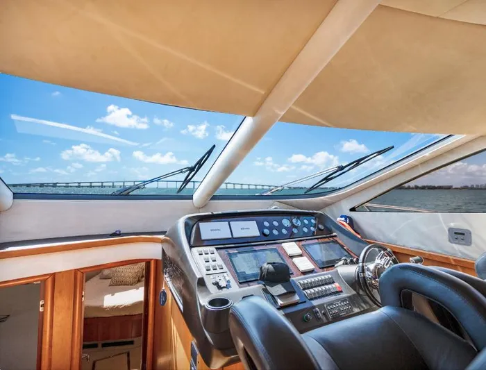 My Sirena Yacht Photos Pics Cockpit view of 2008 Sunseeker Manhattan 70 yacht with modern controls and ocean backdrop.
