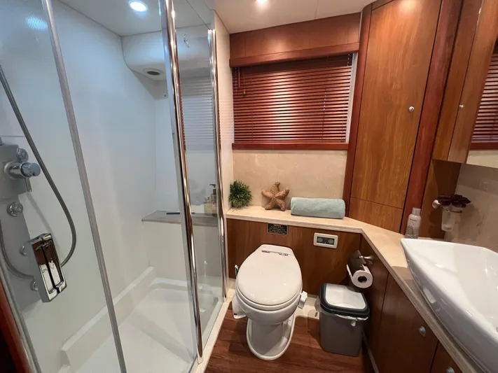 My Sirena Yacht Photos Pics Luxurious bathroom in 2008 Sunseeker Manhattan 70 yacht with modern shower and wooden accents.