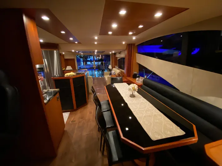 My Sirena Yacht Photos Pics Luxurious interior of 2008 Sunseeker Manhattan 70 yacht with elegant dining area and ambient lighting.