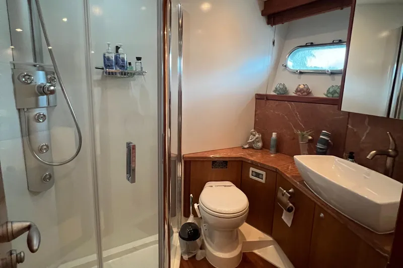 My Sirena Yacht Photos Pics Luxurious bathroom in 2008 Sunseeker Manhattan 70 yacht with shower, toilet, and sink.