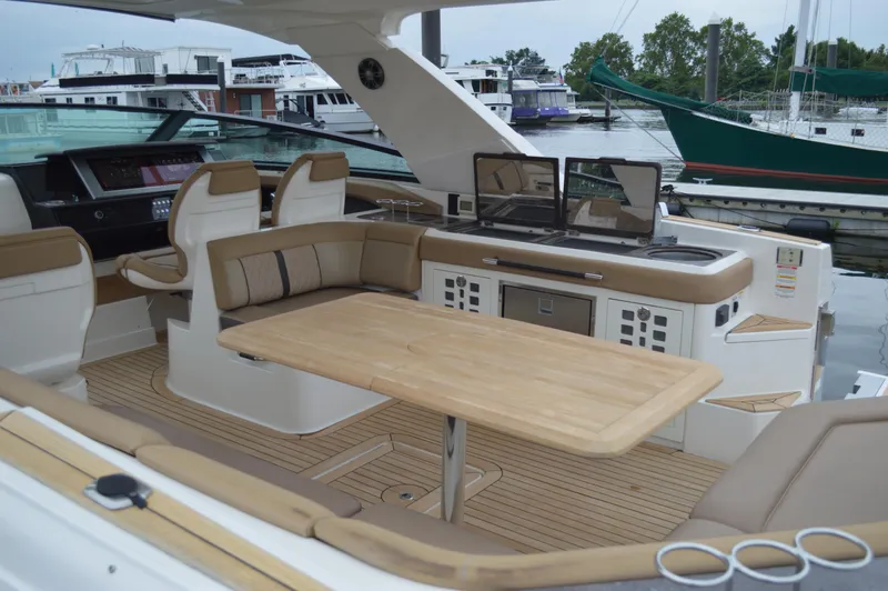 La Santa Yacht Photos Pics 2019 Sea Ray SLX 400 Outboard interior with seating, table, and helm, docked at marina.