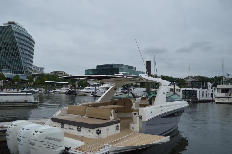 La Santa Yacht Photos Pics 2019 Sea Ray SLX 400 Outboard yacht docked in a marina with modern buildings.