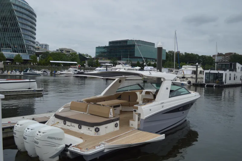 La Santa Yacht Photos Pics 2019 Sea Ray SLX 400 Outboard docked in a marina, surrounded by modern buildings.