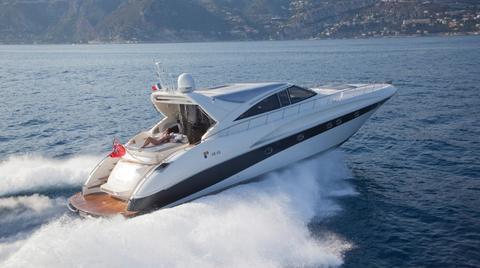 Luxury AB 68 yacht cruising on open water, 2004 model, scenic coastal backdrop.