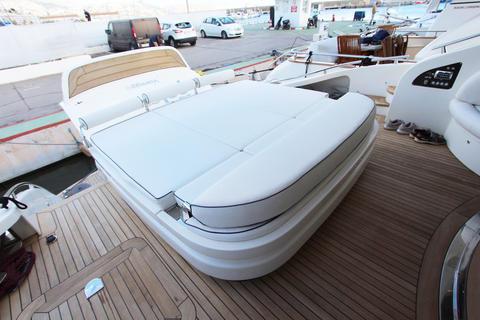 Luxurious yacht deck with cushioned seating, AB 68 model, 2004, docked at marina.