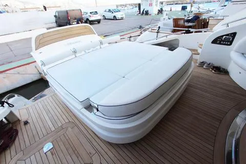 Luxurious yacht deck with cushioned seating, AB 68 model, 2004, docked at marina.