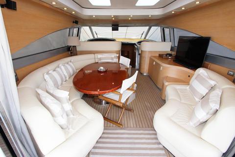 Luxurious yacht interior with cream sofas, wooden table, and modern decor, AB 68 model, 2004.