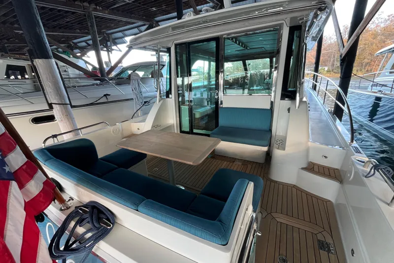 Star Yacht Photos Pics 2019 Sabre 45 Salon Express yacht with outdoor seating and wooden deck.