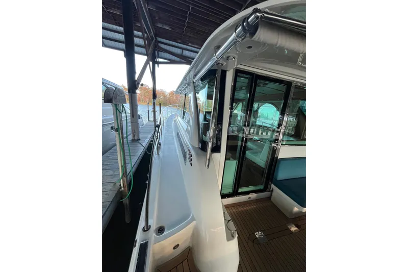 Star Yacht Photos Pics 2019 Sabre 45 Salon Express yacht docked, showcasing sleek exterior and glass doors.