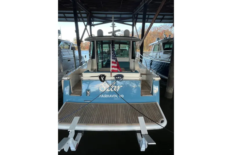 Star Yacht Photos Pics 2019 Sabre 45 Salon Express yacht docked, rear view with American flag.