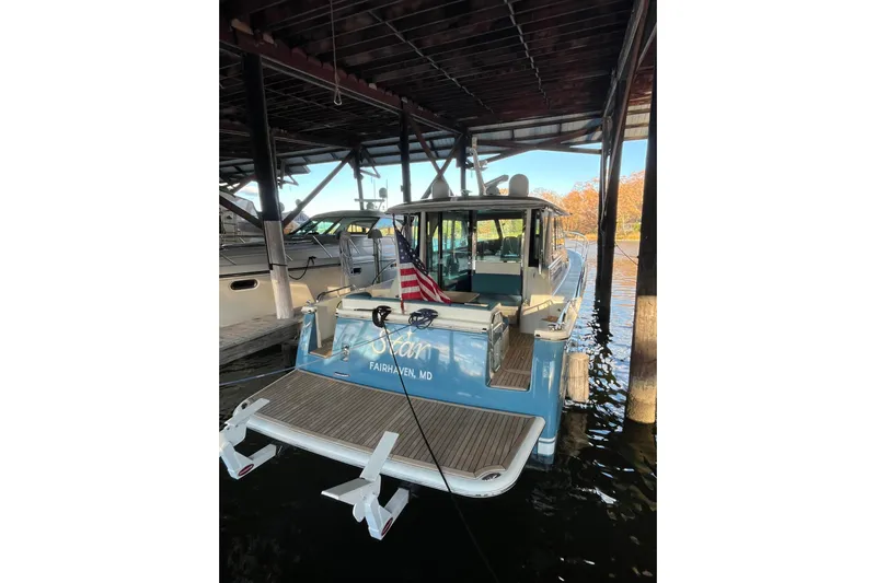 Star Yacht Photos Pics 2019 Sabre 45 Salon Express yacht docked under a covered marina.