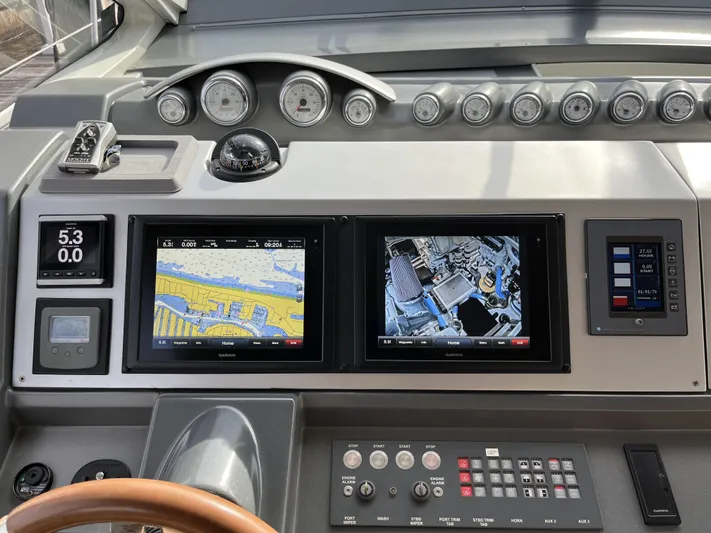 62 Azimut 62s Yacht Photos Pics Control panel of a 2008 Azimut 62S yacht with navigation screens and gauges.