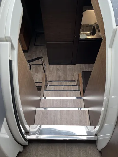 62 Azimut 62s Yacht Photos Pics Staircase inside 2008 Azimut 62S yacht, featuring modern wood and metal design.
