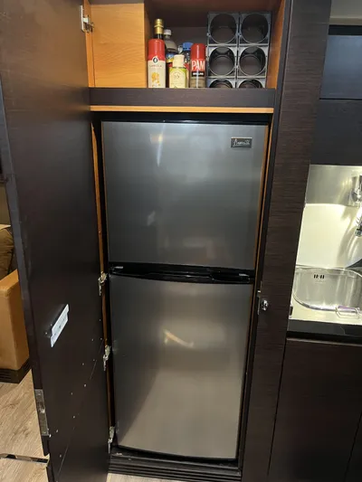 62 Azimut 62s Yacht Photos Pics Built-in fridge in 2008 Azimut 62S yacht kitchen with storage above.