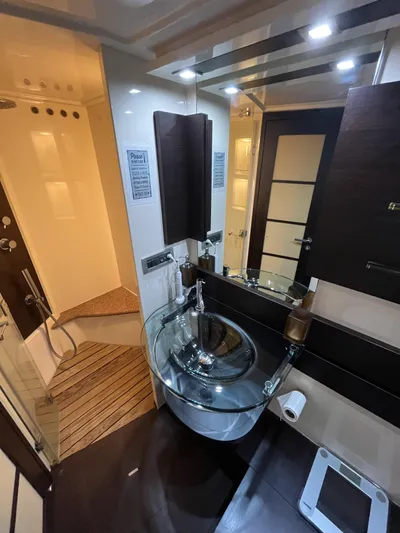 62 Azimut 62s Yacht Photos Pics Luxurious bathroom in 2008 Azimut 62S yacht with modern glass sink and elegant wood accents.