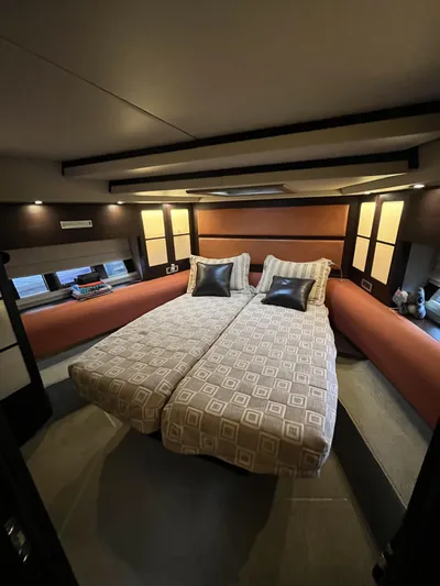 62 Azimut 62s Yacht Photos Pics Luxurious bedroom interior of a 2008 Azimut 62S yacht with twin beds and modern decor.