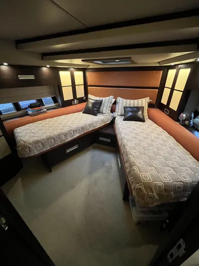 62 Azimut 62s Yacht Photos Pics Luxurious bedroom interior of a 2008 Azimut 62S yacht with twin beds and modern decor.