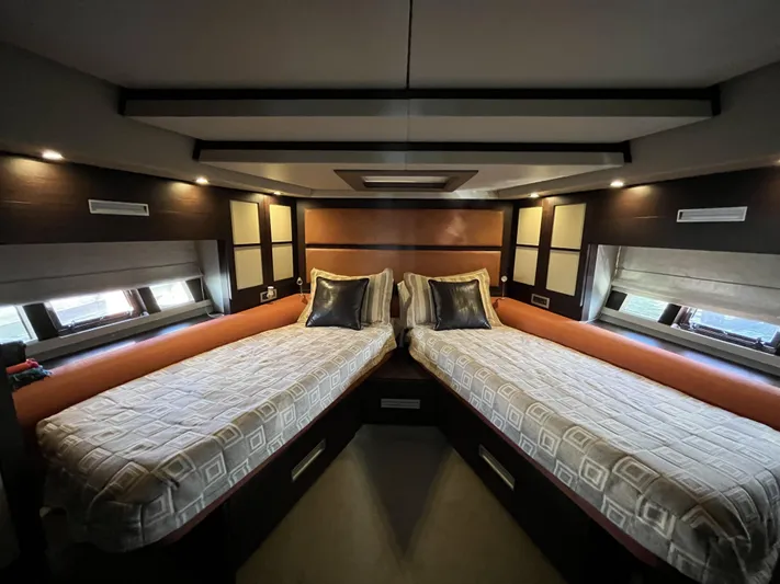 62 Azimut 62s Yacht Photos Pics Luxurious twin cabin interior of 2008 Azimut 62S yacht, featuring modern design and cozy bedding.