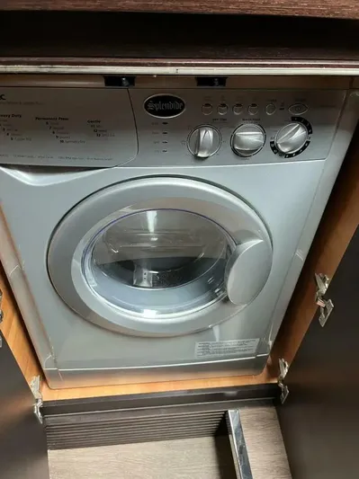 62 Azimut 62s Yacht Photos Pics Washing machine inside 2008 Azimut 62S yacht, featuring control knobs and front-loading door.