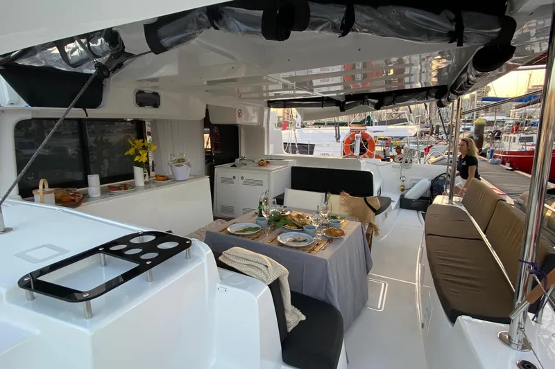 Fregata Lagoon Yacht Photos Pics Luxurious 2023 Lagoon 46 yacht interior with elegant dining setup and comfortable seating.