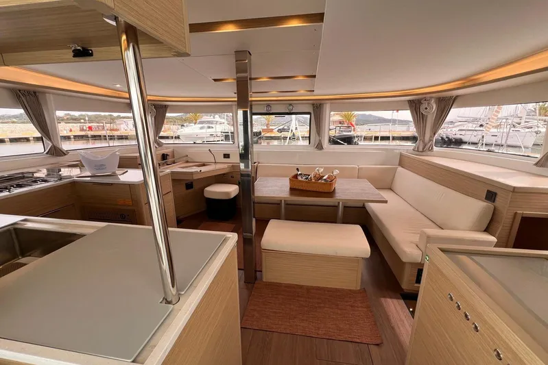 Fregata Lagoon Yacht Photos Pics Luxurious interior of 2023 Lagoon 46 catamaran with modern kitchen and spacious seating area.