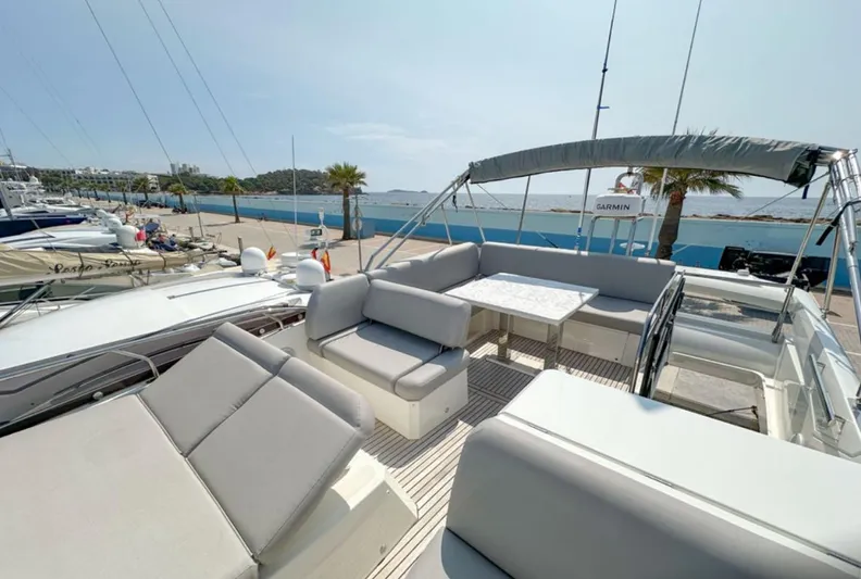 Yacht Photos Pics 2024 Prestige 520 Fly yacht with spacious flybridge and elegant seating area.