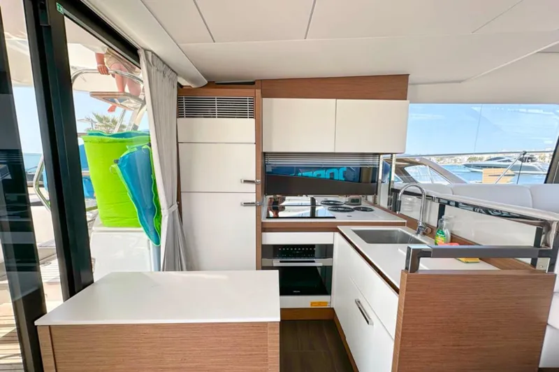  Yacht Photos Pics Modern kitchen interior on 2024 Prestige 520 Fly yacht, featuring sleek cabinetry and appliances.
