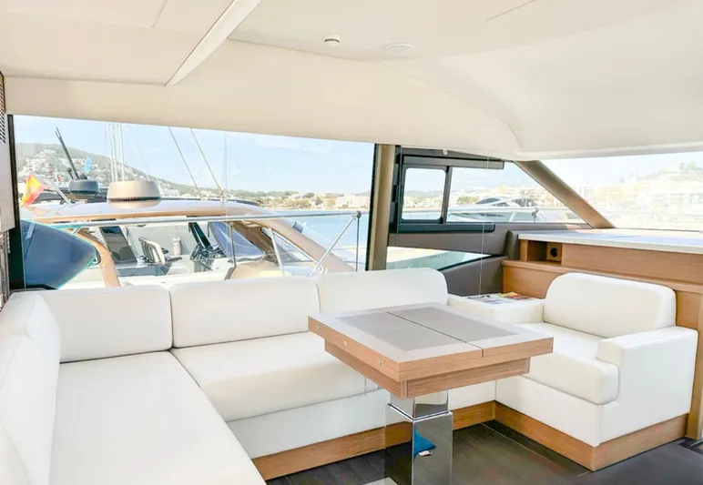  Yacht Photos Pics Luxurious interior of 2024 Prestige 520 Fly yacht with white seating and wooden accents.