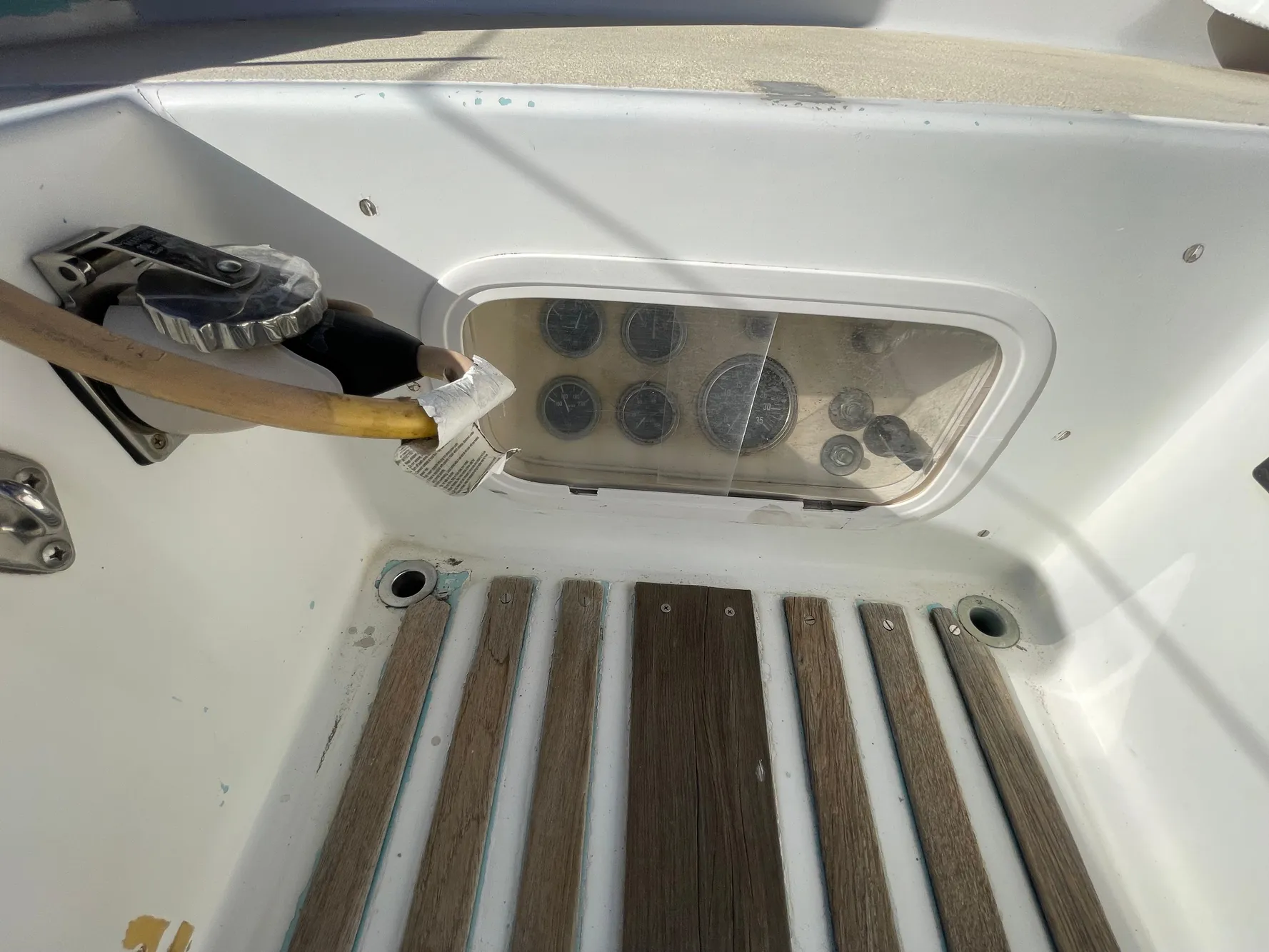 Control panel of a 1964 CAL 40 sailboat with wooden flooring.