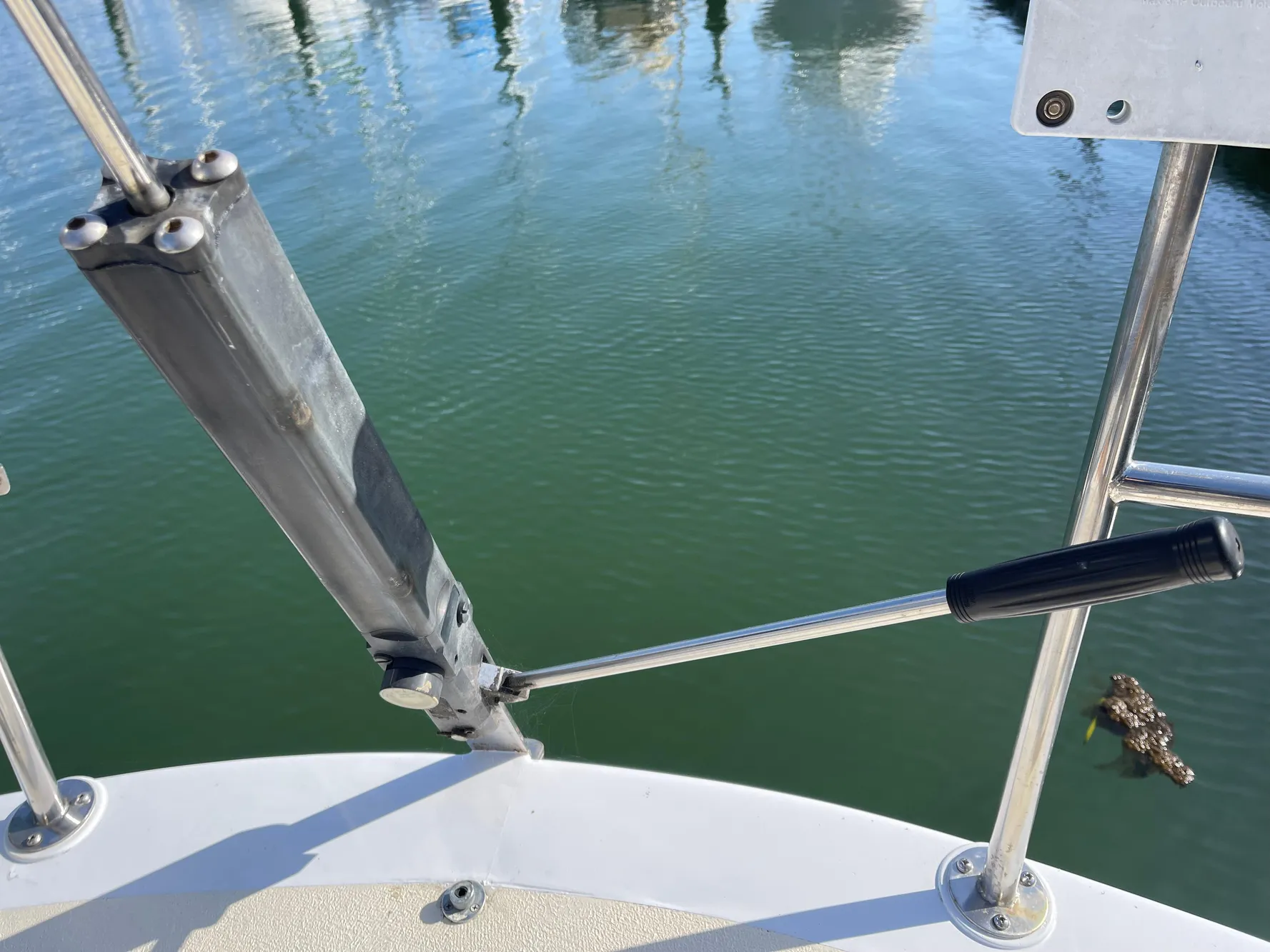 Close-up of a CAL 40 sailboat's deck hardware, 1964 model, with water reflection.