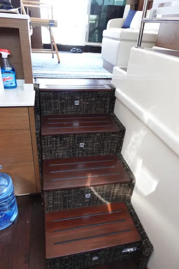  Yacht Photos Pics Staircase inside 2012 Sea Ray 450 Sedan Bridge yacht with wooden steps and modern interior.