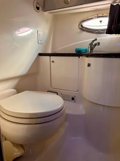  Yacht Photos Pics 2004 Formula 370 Super Sport boat bathroom with toilet, sink, and porthole window.