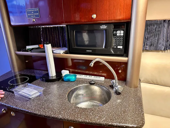  Yacht Photos Pics 2004 Formula 370 Super Sport yacht kitchenette with sink, microwave, and countertop.
